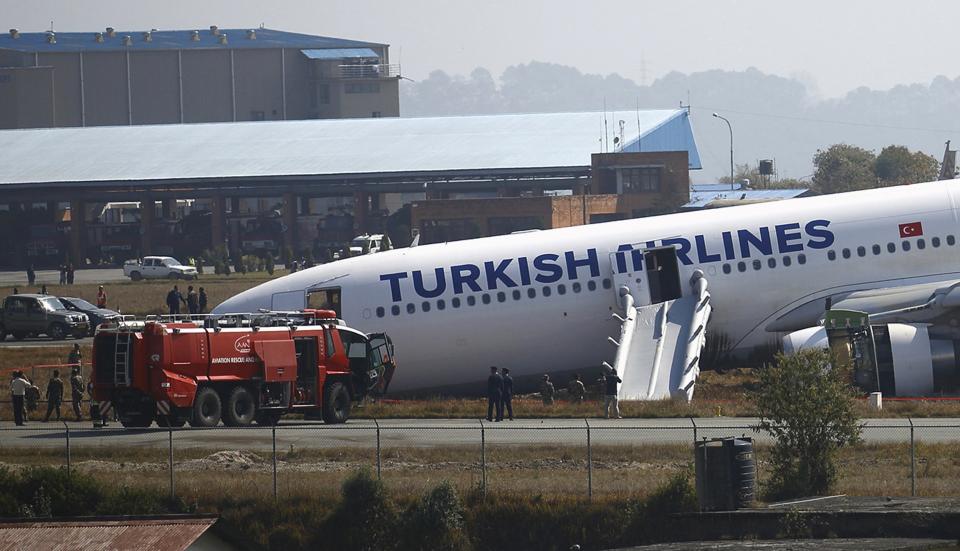 A Turkish Airlines plane lies on the field after it overshot the runway at Tribhuvan International Airport in Kathmandu