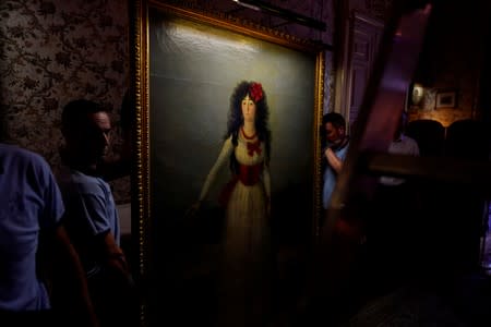 Workers carry "XIII Duchess of Alba" painting by the Spanish painter Francisco Goya at Liria Palace in Madrid