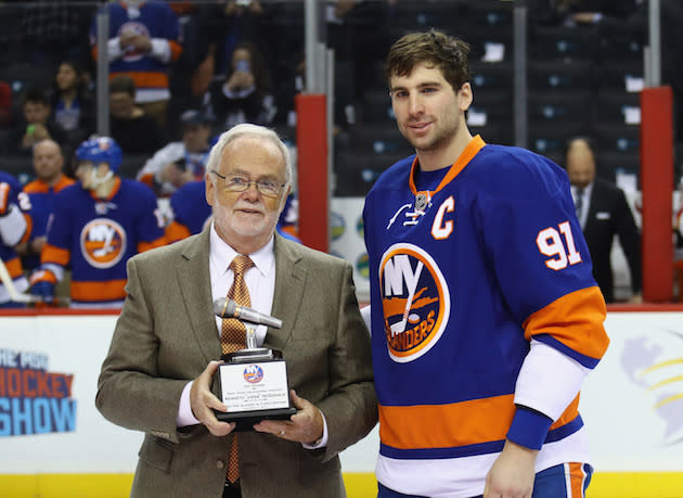 NEW YORK, NY - JANUARY 11: Former New York Islanders broadcaster Jiggs McDonald (L) is honored prior to the game against the Florida Panthers and accepts a trophy from John Tavares #91 at the Barclays Center on January 11, 2017 in the Brooklyn borough of New York City. (Photo by Bruce Bennett/Getty Images)