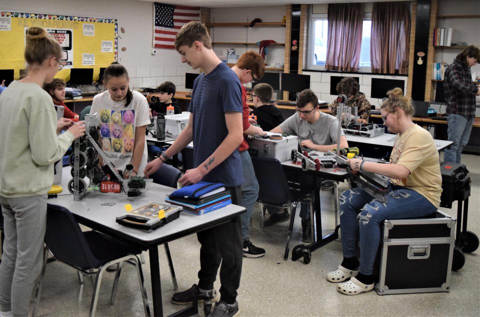 Eighth-grade students in Brooke Fox's robotics class work on their robot. The students learn the value of teamwork, creativity and numerous other skills in the fledgling program at West Holmes.