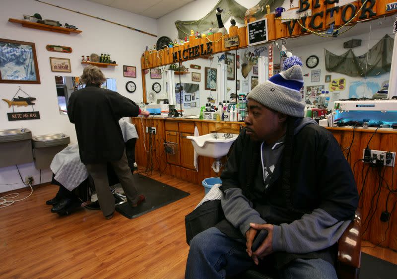 Victor Burch waits for customers in his barber shop in Livonia