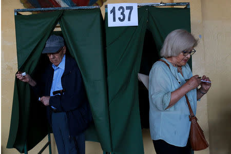 Citizens leave from voting booths inside a polling station during the presidential election at Santiago, Chile December 17, 2017. REUTERS/Pablo Sanhueza
