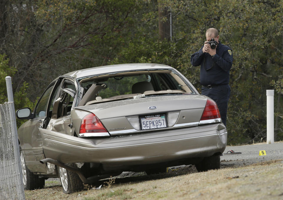 <p>A California Highway patrol officer photographs a vehicle involved in a deadly shooting rampage at the Rancho Tehama Reserve, near Corning, Calif., Nov. 14, 2017. (Photo: Rich Pedroncelli/AP) </p>