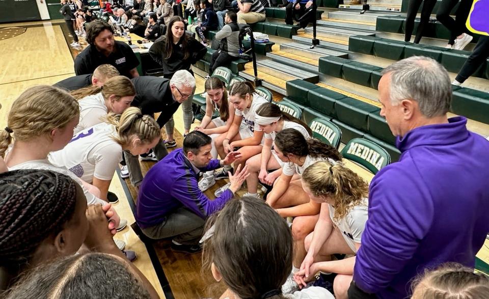 Head coach Anthony Butch talks with his Jackson girls basketball team during this year's Division I district championship game against Solon.