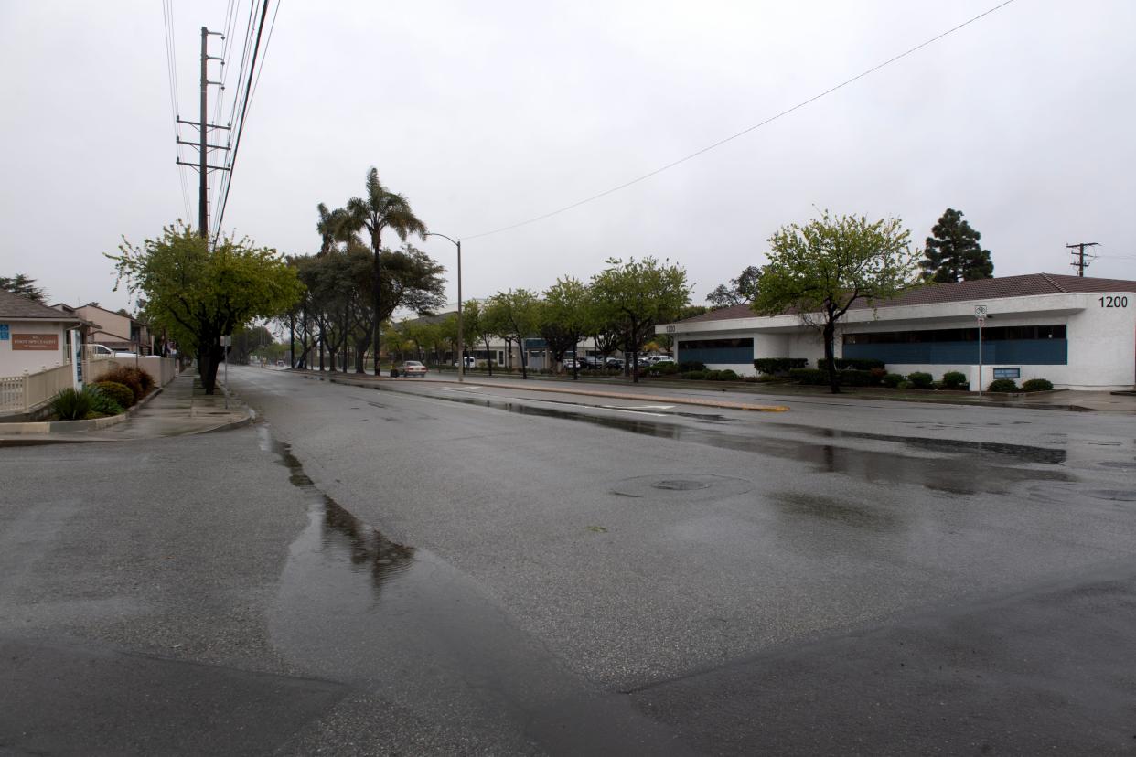 Rain falls Friday on the 1200 block of West Gonzales Road in Oxnard where a man was fatally shot in December. A suspect was charged with murder on Thursday.