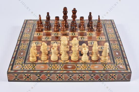 Vintage wooden chess set with queen gambit opening, close-up view