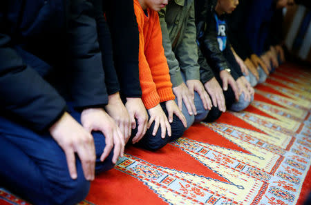 Muslims pray during Friday prayers at the Turkish Kuba Camii mosque located near a hotel housing refugees in Cologne's district of Kalk, Germany, October 14, 2016. REUTERS/Wolfgang Rattay
