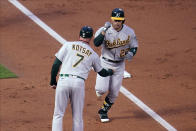 Oakland Athletics' Ramon Laureano (22) is congratulated by third base coach Mark Kotsay as he jogs home on a solo home run off Minnesota Twins pitcher Matt Shoemaker during the third inning of a baseball game Friday, May 14, 2021, in Minneapolis. (AP Photo/Jim Mone)