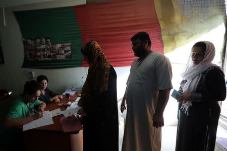 People register their names before voting at a polling station in Qamishli, Syria September 22, 2017. REUTERS/Rodi Said