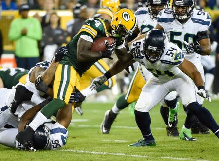 Green Bay Packers running back James Starks (44) tries to break a tackle by Seattle Seahawks linebacker Bobby Wagner (54) in the second quarter at Lambeau Field. Sep 20, 2015; Green Bay, WI, USA. Benny Sieu-USA TODAY Sports