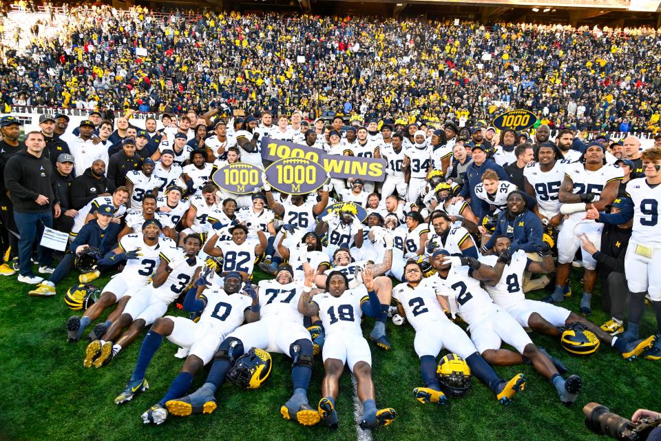 The Michigan Wolverines celebrate the program's 1,000th win, which came against the Maryland Terrapins in November.