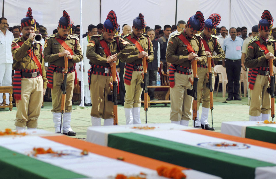 Indian security personnel pay homage to paramilitary soldiers killed in an ambush by Maoist rebels, in Jagdalpur, in the eastern Indian state of Chhattisgarh, Wednesday, March 12, 2014. Maoist insurgents will not be allowed to spoil next month's Indian elections with violent attacks, the home minister said Wednesday, a day after rebels killed 16 people in their deadliest raid in almost a year. (AP Photo)