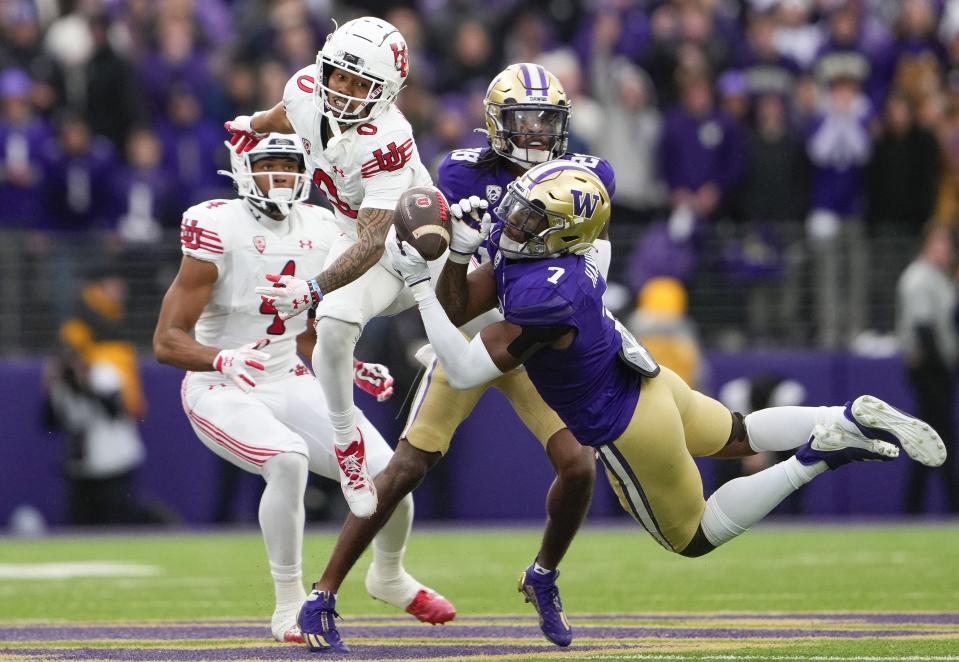 Washington cornerback Dominique Hampton (7) makes an interception against Utah wide receiver Mikey Matthews (0) during the second half of an NCAA college football game Saturday, Nov. 11, 2023, in Seattle. | Lindsey Wasson, Associated Press