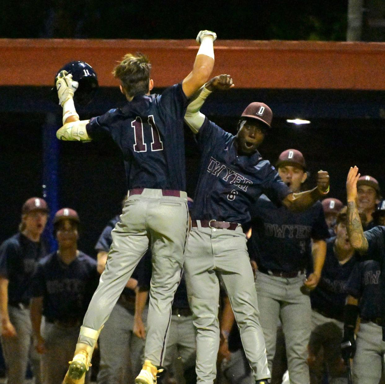 Dwyer teammates Kody Morgan (left) Chris Jackson (right) celebrate Morgan's home-run, a hit that broke the Panthers' game against Palm Beach Gardens wide open on Mar. 21, 2024.