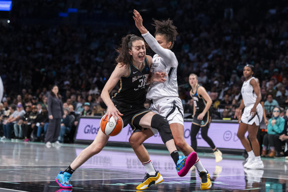 New York Liberty forward Breanna Stewart (30) is defended by Las Vegas Aces forward Alysha Clark (7) during the first half of a WNBA basketball second-round playoff game, Sunday, Sept. 29, 2024, in New York. (AP Photo/Corey Sipkin)