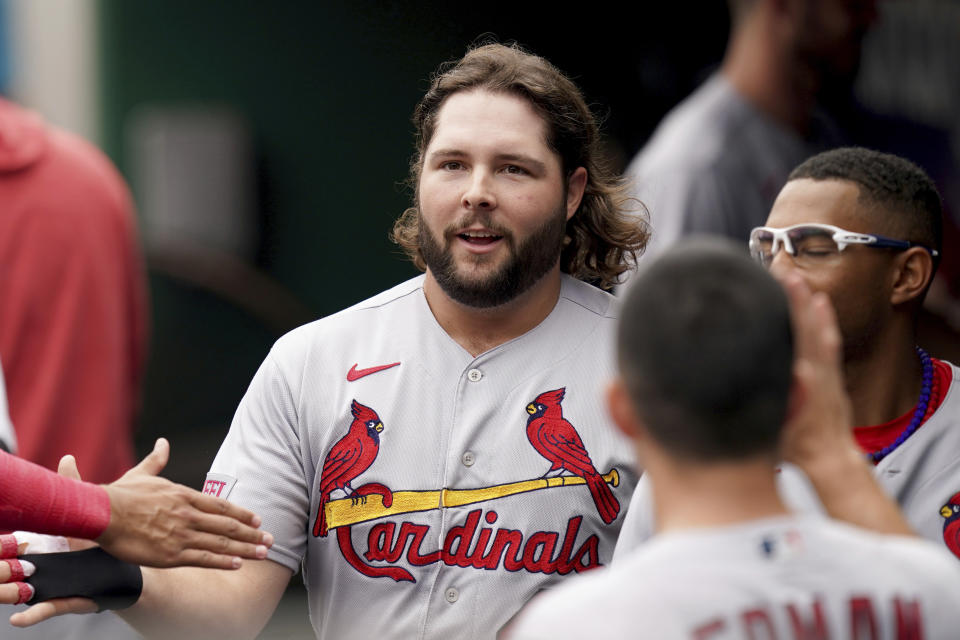 St. Louis Cardinals' Alec Burleson celebrates in the dugout after scoring on an RBI single hit by Paul Goldschmidt against the Pittsburgh Pirates in the first inning of a baseball game in Pittsburgh, Wednesday, Aug. 23, 2023. (AP Photo/Matt Freed)