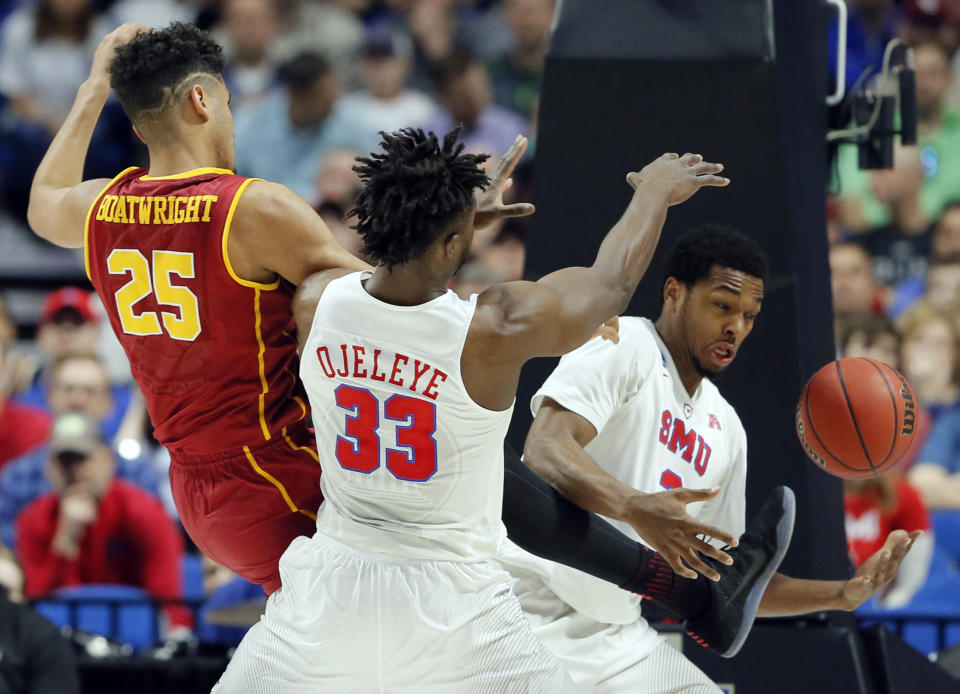 SMU's Semi Ojeleye (33) and Sterling Brown, right, combine to grab a rebound in front of USC's Bennie Boatwright (25) in the first half of a first-round game in the men's NCAA college basketball tournament in Tulsa, Okla., Friday March 17, 2017. (AP Photo/Tony Gutierrez)