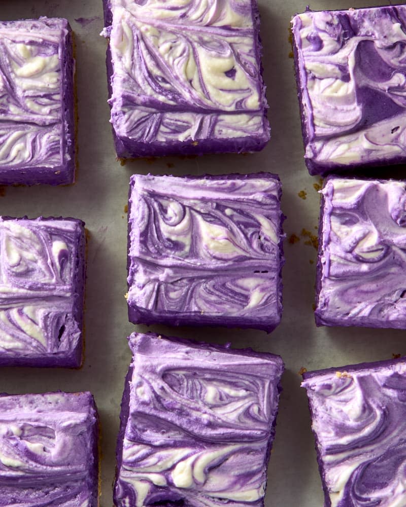 No bake ube bar dessert from overhead showing swirls of cream cheese and purple ube.
