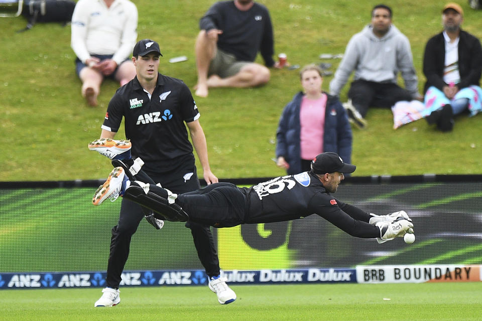 New Zealand wicketkeeper Tom Blundell is airborne as he attempts a catch during the first One Day cricket international between New Zealand and Bangladesh at University Oval in Dunedin, New Zealand, Sunday, Dec. 17, 2023. (Chris Symes/Photosport via AP)