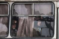 Miners sit on a bus as they arrive at the Zasyadko coal mine in Donetsk March 4, 2015. REUTERS/Baz Ratner