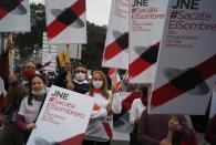 Supporters of Peru's presidential candidate holds signs during a demonstration in Lima