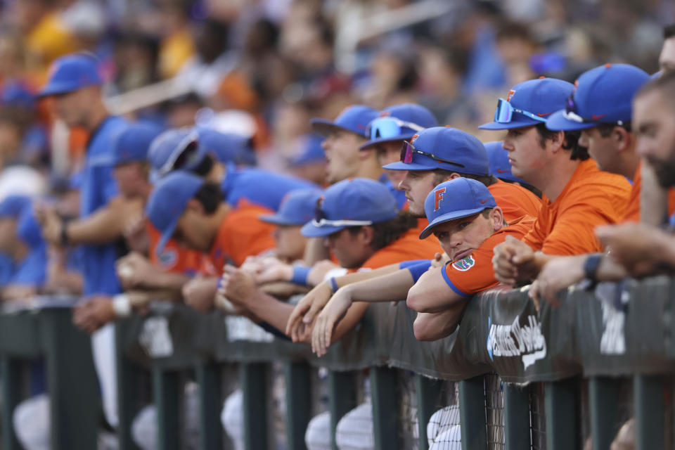 The Florida dugout watches in the seventh inning of Game 3 of the NCAA College World Series baseball finals against LSU in Omaha, Neb., Monday, June 26, 2023. (AP Photo/Rebecca S. Gratz)