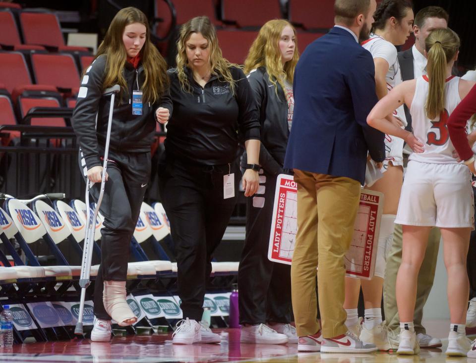 Injured Morton senior Maggie Hobson stands with a crutch for a timeout during the second half of the Class 3A state semifinals Friday, March 4, 2022 at Redbird Arena in Normal. The Potters fell to the Nazareth Academy Roadrunners 55-24.