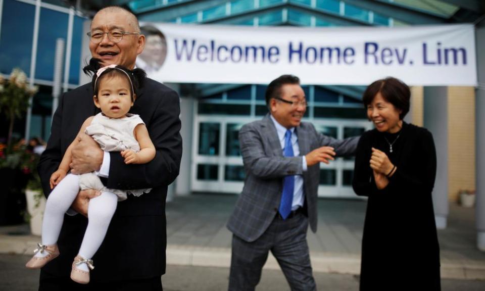 Pastor Hyeon Soo Lim, who returned to Canada from North Korea on 9 August, holds his granddaughter as he leaves the Light Presbyterian Church in Mississauga.