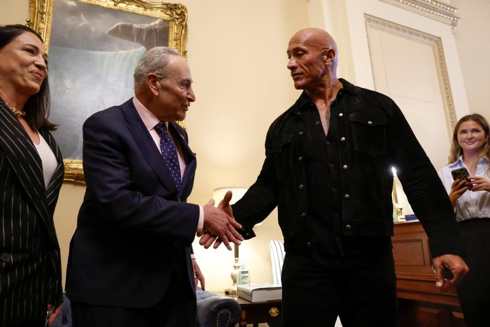 Dwayne Johnson shakes hands with U.S. Majority Leader Chuck Schumer at the Capitol Building on 15 November 2023 (Anna Moneymaker/Getty Images)