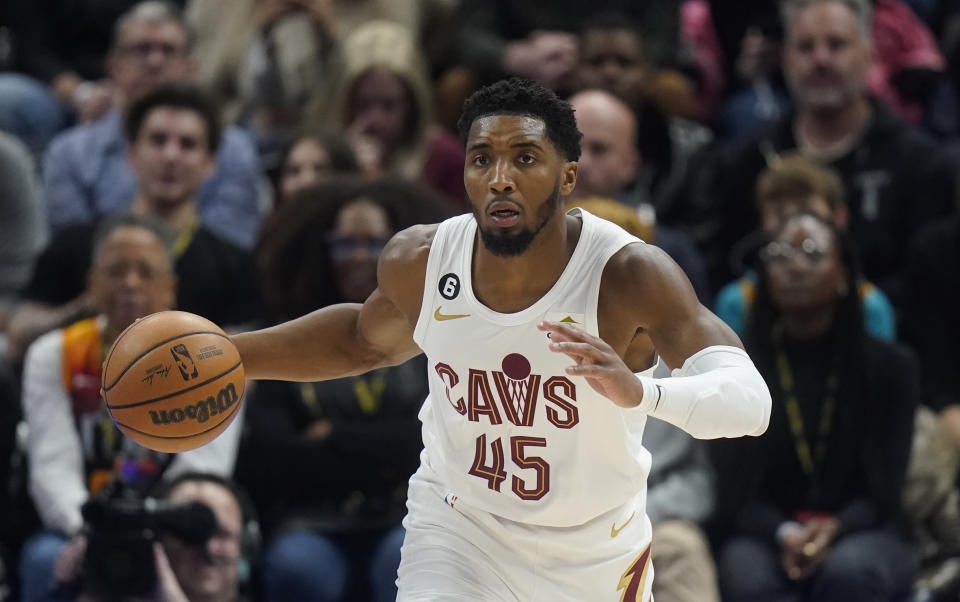Cleveland Cavaliers guard Donovan Mitchell (45) brings the ball up during the first half of the team's NBA basketball game against the Utah Jazz on Tuesday, Jan. 10, 2023, in Salt Lake City. (AP Photo/Rick Bowmer)