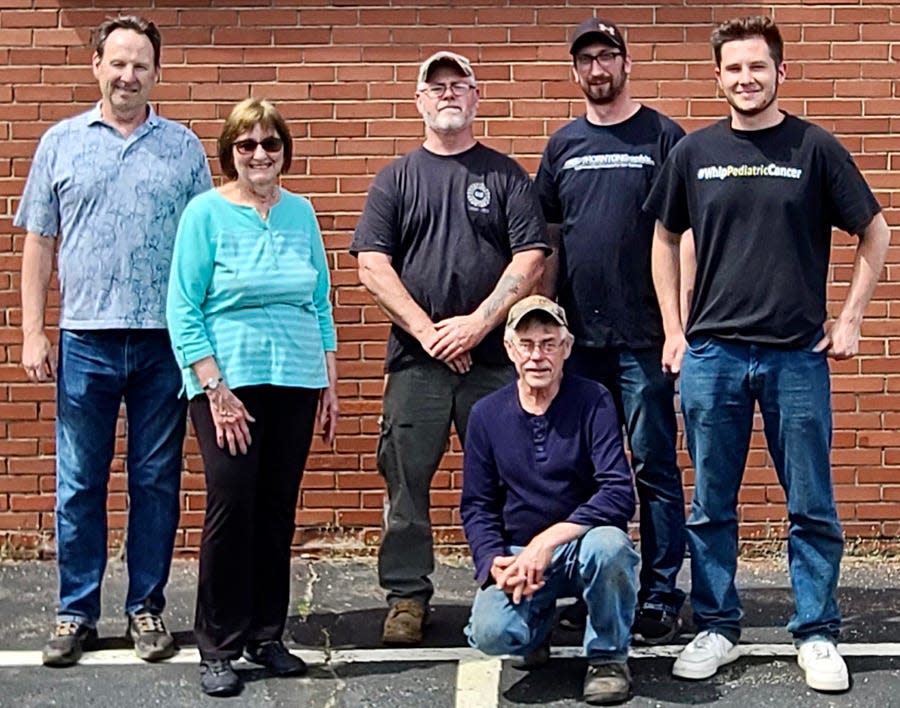One year after his tragic death, friends and family came together to create a tribute to Jeff Chorba, who was killed in a paramotoring accident near Beach Lake. Pictured here are (from left): Joe Parker, Eileen Chorba, Paul Bates, Jason Marold, Griffon Seales. Kneeling is Bob Rickert. Not shown: Nate Marold and Billy Thornton.