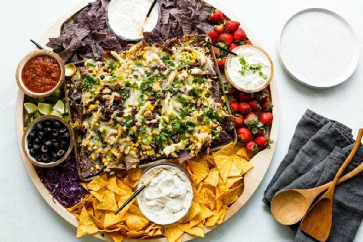 <p>Reluctant Entertainer</p><p>This nacho board comes together in 30 minutes, and everyone will love it.</p><p><strong>Get the recipe: </strong><a href="https://reluctantentertainer.com/baked-nacho-board/" rel="nofollow noopener" target="_blank" data-ylk="slk:Game-Day Baked Nacho Board;elm:context_link;itc:0;sec:content-canvas" class="link rapid-noclick-resp"><strong>Game-Day Baked Nacho Board</strong></a></p>