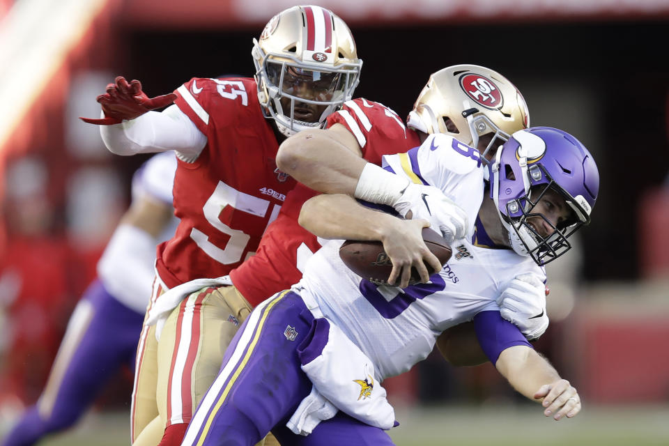 Minnesota Vikings quarterback Kirk Cousins, foreground, is tackled by San Francisco 49ers defensive end Nick Bosa, center, during the second half of an NFL divisional playoff football game, Saturday, Jan. 11, 2020, in Santa Clara, Calif. Also pictured at rear is defensive end Dee Ford. (AP Photo/Ben Margot)