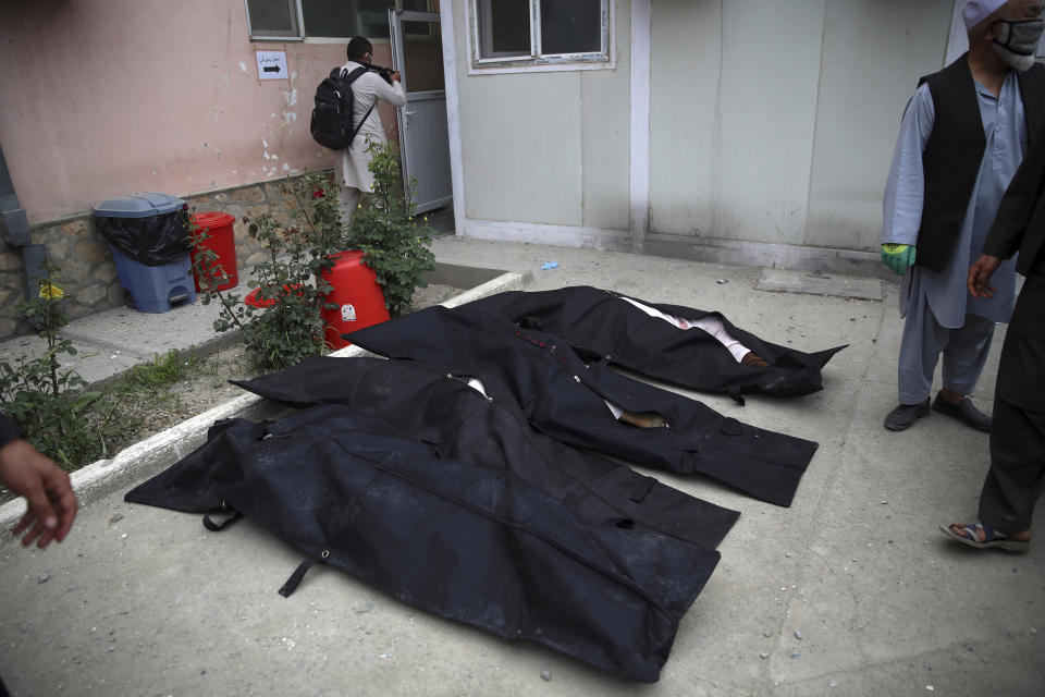 Bodies of victims of a deadly attack at a maternity hospital lie on the ground, in Kabul, Afghanistan, Tuesday, May 12, 2020. Gunmen stormed the hospital in the western part of Kabul on Tuesday, setting off a shootout with the police and killing several people. (AP Photo/Rahmat Gul)