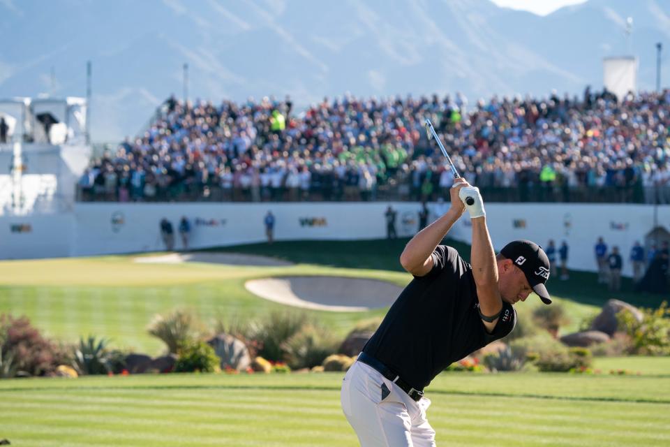 Justin Thomas plays his tee shot on the par 3 16th hole during the second round of the WM Phoenix Open golf tournament. Mandatory Credit: Allan Henry-USA TODAY Sports