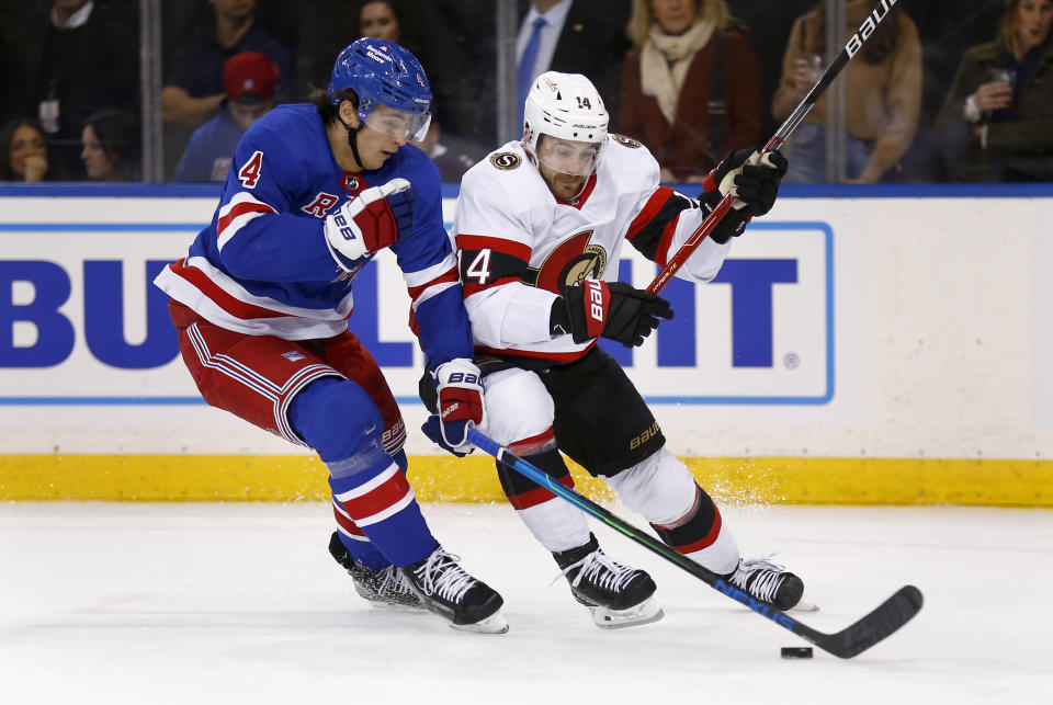 New York Rangers defenseman Braden Schneider, left, and Ottawa Senators left wing Tyler Motte (14) skate for the puck during the first period of an NHL hockey game Friday, Dec. 2, 2022, in New York. (AP Photo/John Munson)