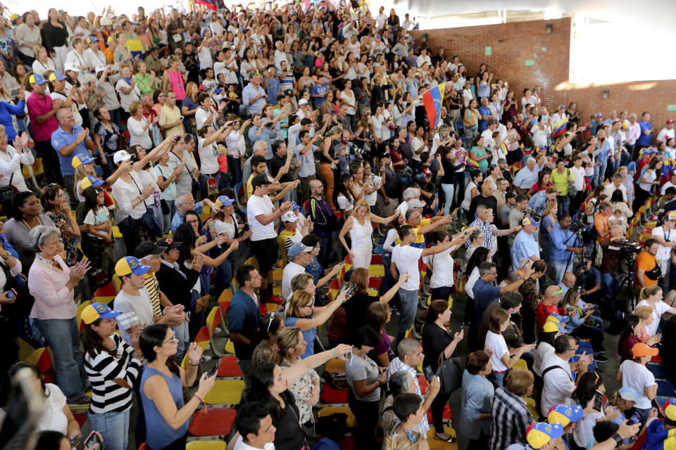 Supporters of the National Assembly President Juan Guaido, cheer for him during a meeting with residents in the Hatillo municipality of Caracas, Venezuela, Thursday, March 14, 2019. Guaido has declared himself interim president and demands new elections, arguing that President Nicolas Maduro's re-election last year was invalid. (AP Photo/Fernando Llano)