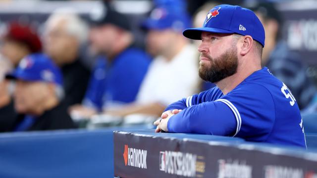 Toronto Blue Jays manager John Schneider, left, plays with his