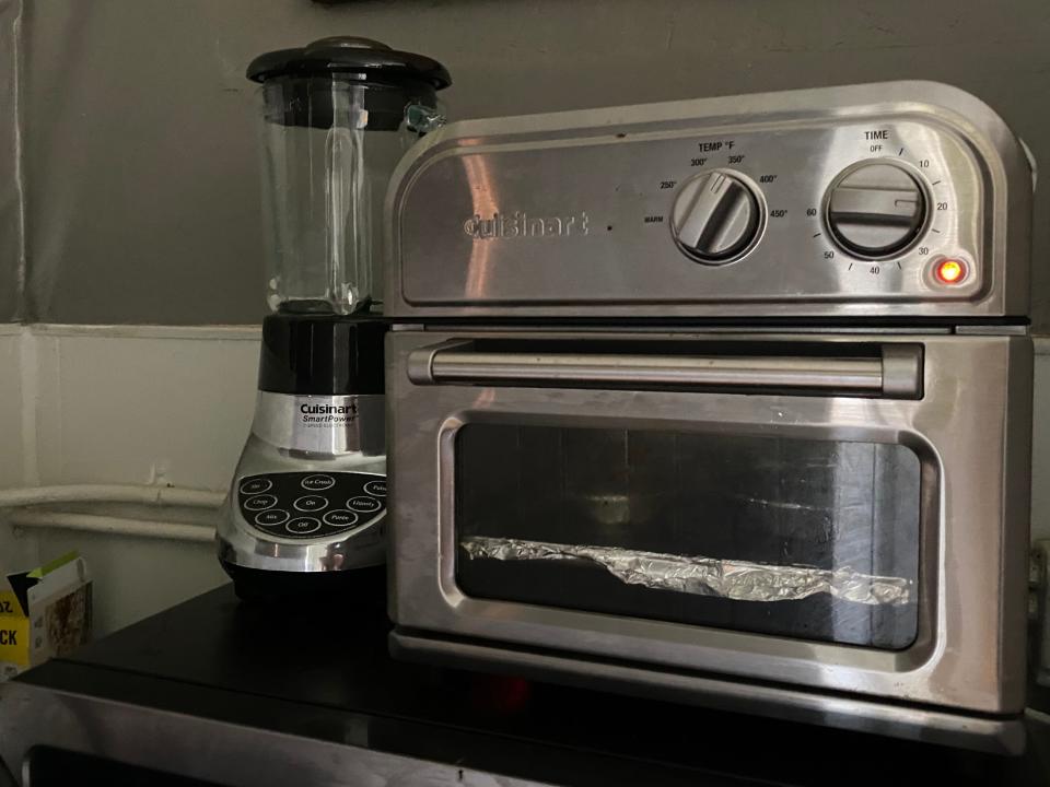 A air fryer oven next to a blender