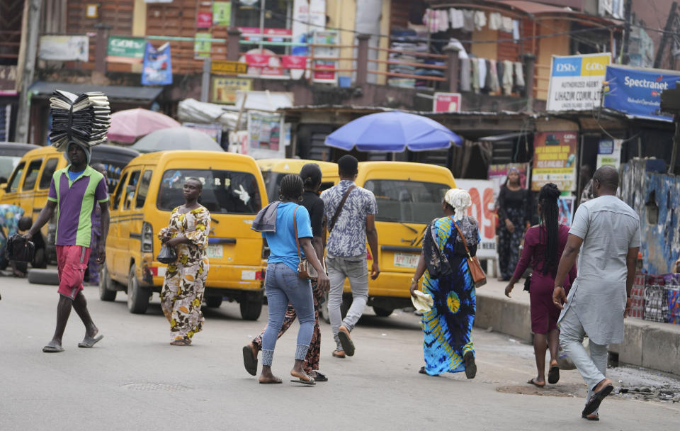 Pedestrians cross a busy streets in Lagos, Nigeria, Tuesday Sept. 5, 2023. (AP Photo/Sunday Alamba)