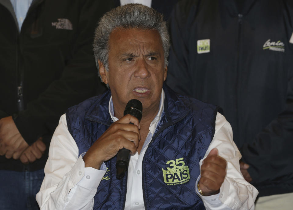 Lenin Moreno, presidential candidate for the ruling party Alliance PAIS, center, speaks during a news conference where he said, "no to violence" as Ecuadoreans wait for results of the presidential race, in Quito, Ecuador, Monday, Feb. 20, 2017. The hand-picked candidate of President Rafael Correa, Moreno held an easy lead Monday in Ecuador's presidential election, though authorities said it might be a few more days before they determine if Moreno won enough votes to avoid a runoff against his nearest rival. (AP Photo/Dolores Ochoa)