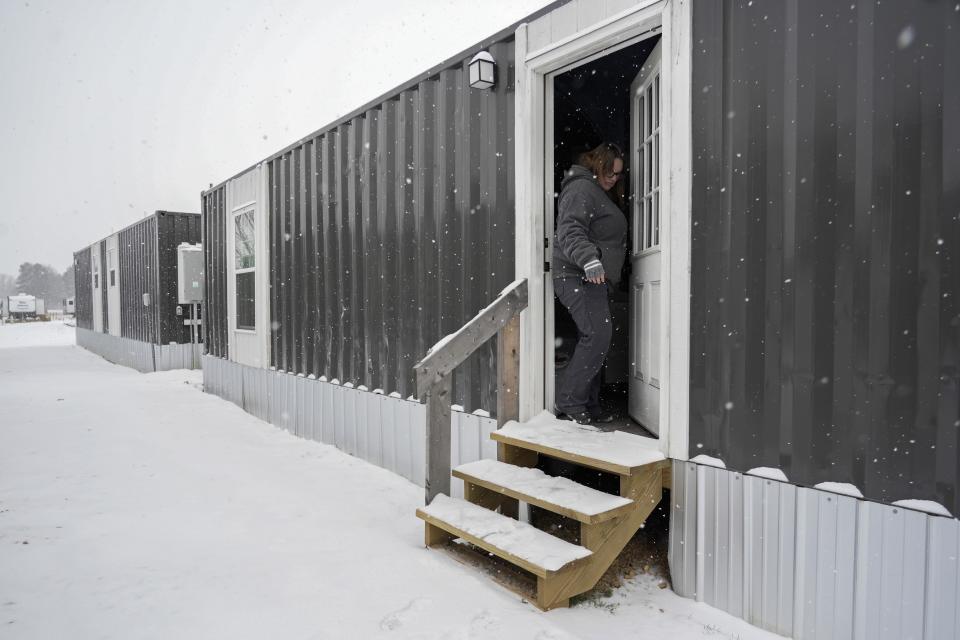 Cassy Basham, office manager at Camp Graves, a nonprofit helping provide temporary housing, leaves a temporary housing unit after checking on the heat and pipes, Monday, Jan. 15, 2024, in Water Valley, Ky. Basham says she does everything she can to make people feel supported in spite of the challenges they have faced. (AP Photo/Joshua A. Bickel)