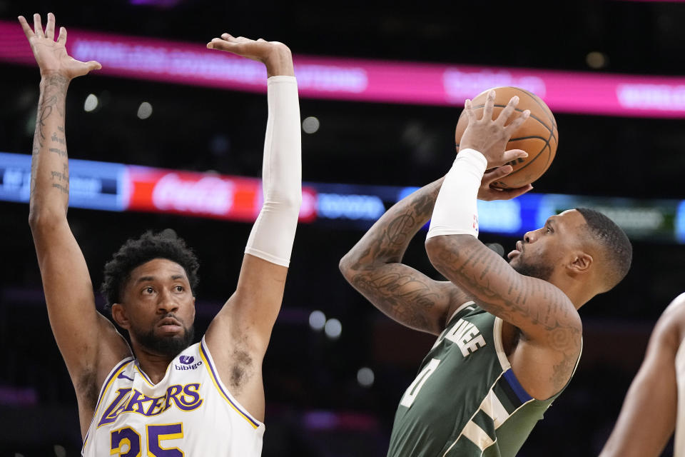 Milwaukee Bucks forward MarJon Beauchamp, right, shoots as Los Angeles Lakers forward Christian Wood defends during the first half of an NBA preseason basketball game Sunday, Oct. 15, 2023, in Los Angeles. (AP Photo/Mark J. Terrill)