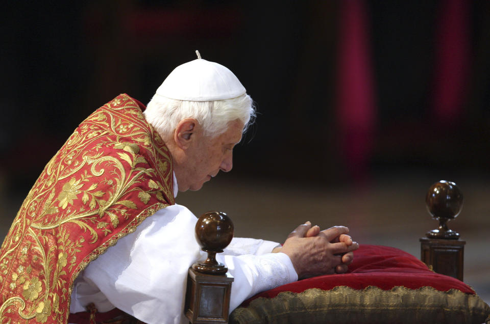 FILE - Pope Benedict XVI kneels during a service in St. Peter's Basilica at the Vatican on April 2, 2010, as pilgrims and tourists flock to the Vatican ahead of Good Friday ceremonies. At the same time, the Catholic church was defending itself against accusations that Benedict played a role in covering up sex abuse cases. Pope Benedict XVI rarely got credit for having turned the Vatican around on clergy sexual abuse, but as cardinal and pope, he pushed through revolutionary changes to church law to make it easier to defrock predator priests. (AP Photo/Alessandra Tarantino, File)