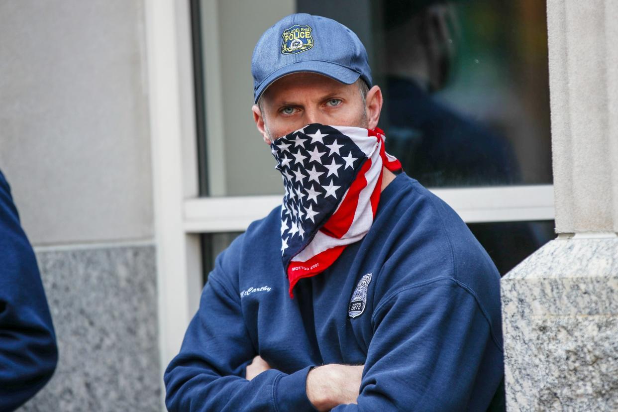 NOVEMBER 06: A cop is seen with the U.S flag mask on as Trump and Biden supporters gathered at the ballot counting center in Philadelphia, Pennsylvania on November 6, 2020. (Photo by Tayfun Coskun/Anadolu Agency via Getty Images)