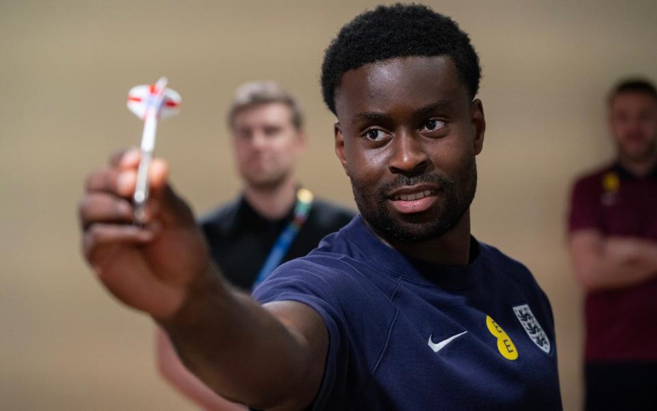 Defender Marc Guehi playing darts against the media