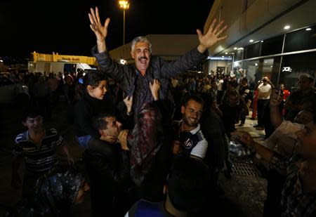 One of the nine newly released Lebanese hostages, who were held by rebels in northern Syria, gestures as he is welcomed by his relatives upon his arrival at Beirut international airport, October 19, 2013. REUTERS/Mohamed Azakir