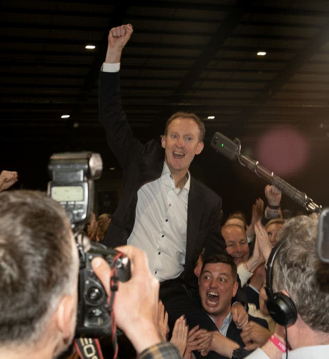 Barry Andrews is hoisted into the air following his election