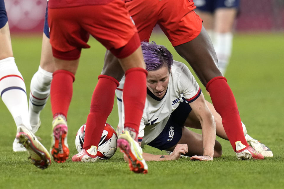 United States' Megan Rapinoe falls to the ground during a women's semifinal soccer match against Canada at the 2020 Summer Olympics, Monday, Aug. 2, 2021, in Kashima, Japan. (AP Photo/Fernando Vergara)