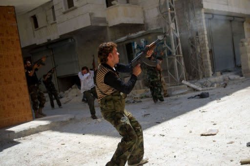 Syrian rebels fire towards an army sniper in the Salaheddin district of the northern city of Aleppo. President Bashar al-Assad's regime has faced mounting pressure as foreign ministers called for Syria to be suspended from the 57-nation Islamic Cooperation Organization over the brutal crackdown on the 17-month rebellion